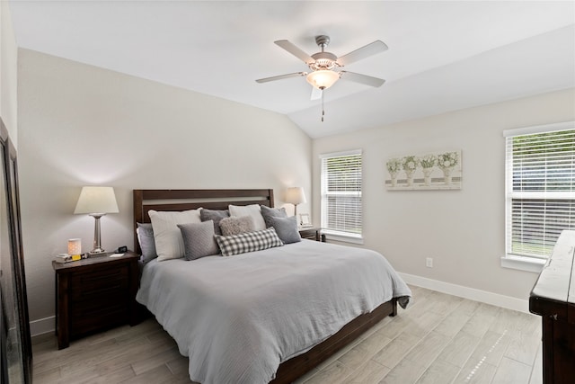 bedroom with light hardwood / wood-style floors, ceiling fan, and vaulted ceiling