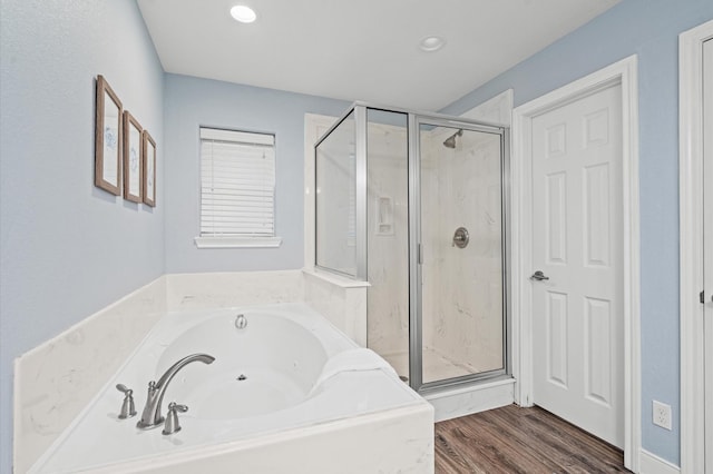 bathroom featuring hardwood / wood-style flooring and separate shower and tub