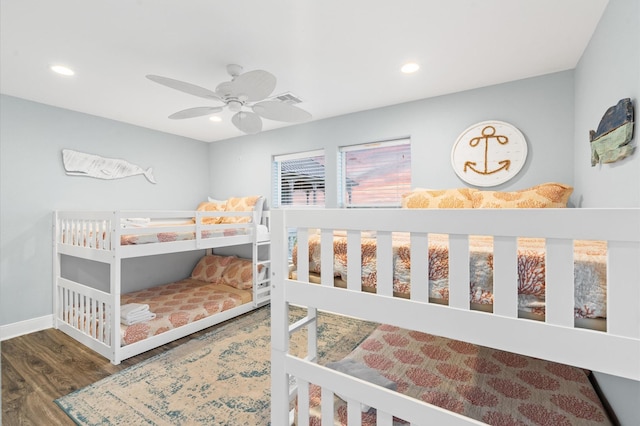 bedroom with ceiling fan and dark wood-type flooring