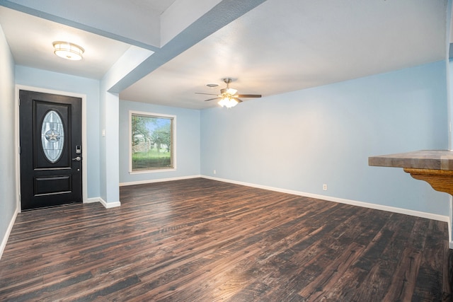 interior space with dark wood-type flooring and ceiling fan