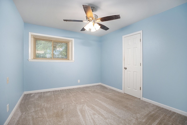 unfurnished room featuring ceiling fan and carpet flooring