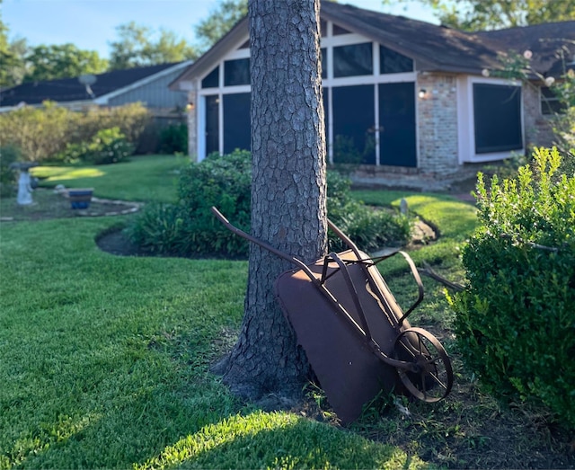 view of side of home with a yard