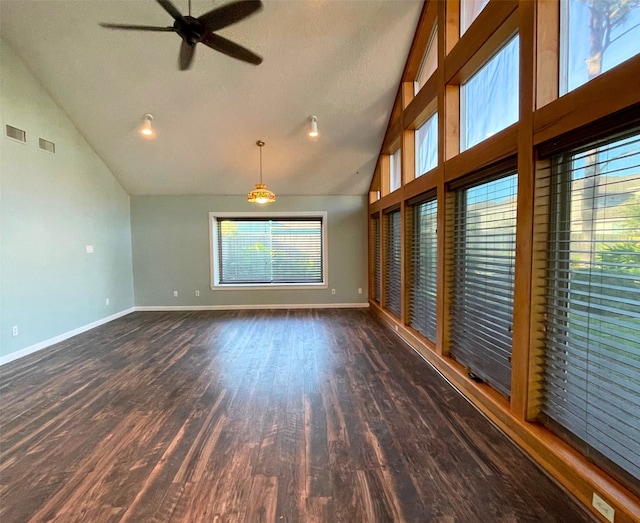 spare room with dark wood-type flooring, a textured ceiling, high vaulted ceiling, and ceiling fan