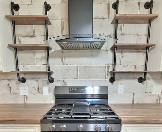 kitchen featuring island range hood, stainless steel stove, and wood counters