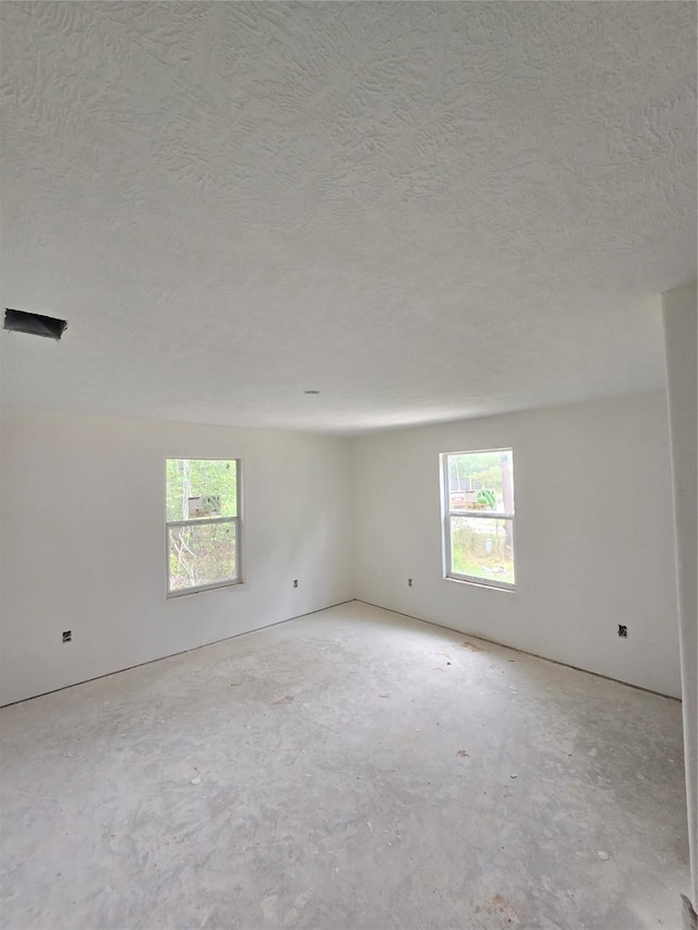 spare room with a textured ceiling