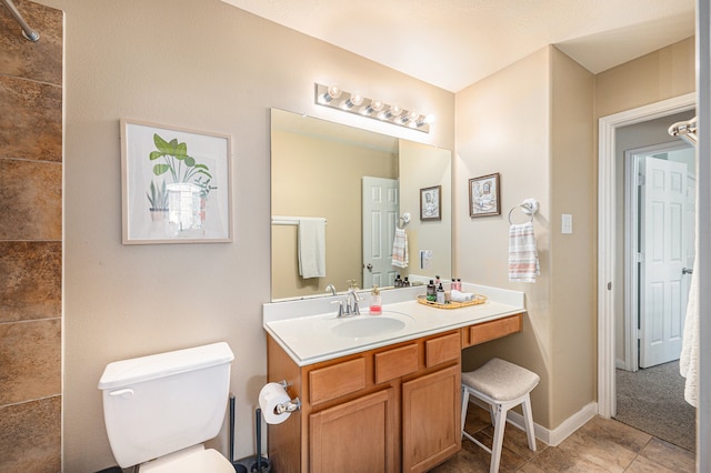 bathroom with vanity, toilet, and tile patterned floors