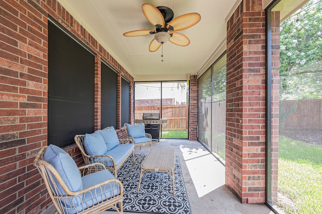 unfurnished sunroom with ceiling fan