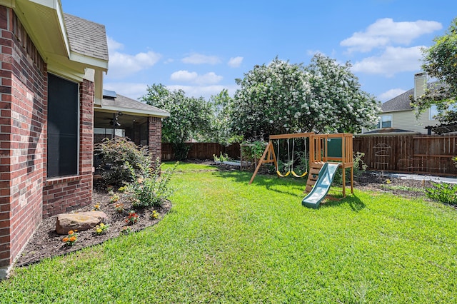 view of yard with a playground and ceiling fan