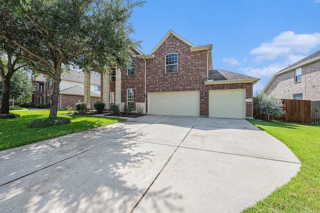 view of property with a garage and a front yard