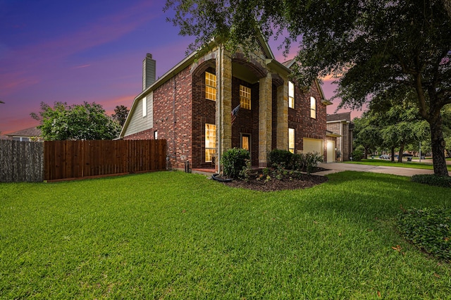 view of front of home featuring a yard and a garage