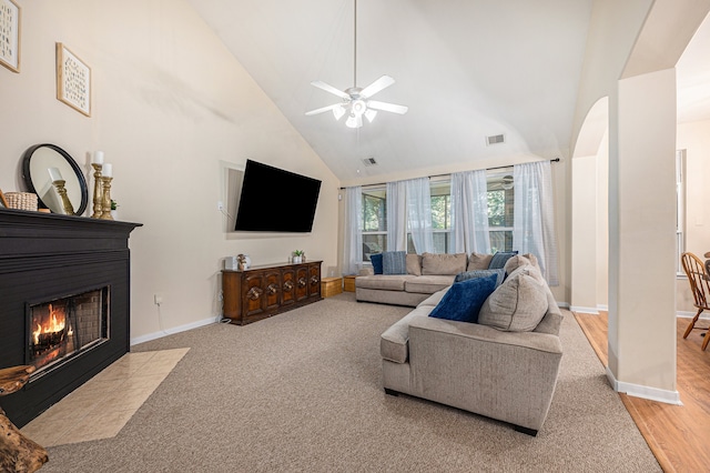 living room featuring high vaulted ceiling, ceiling fan, and light hardwood / wood-style floors