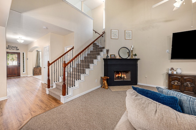 living room with ceiling fan and light hardwood / wood-style floors