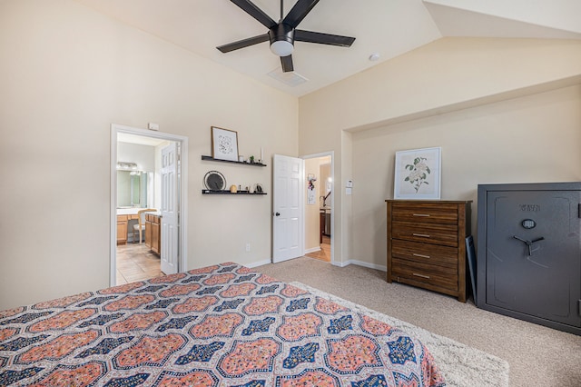 bedroom featuring light colored carpet, ceiling fan, high vaulted ceiling, and ensuite bathroom