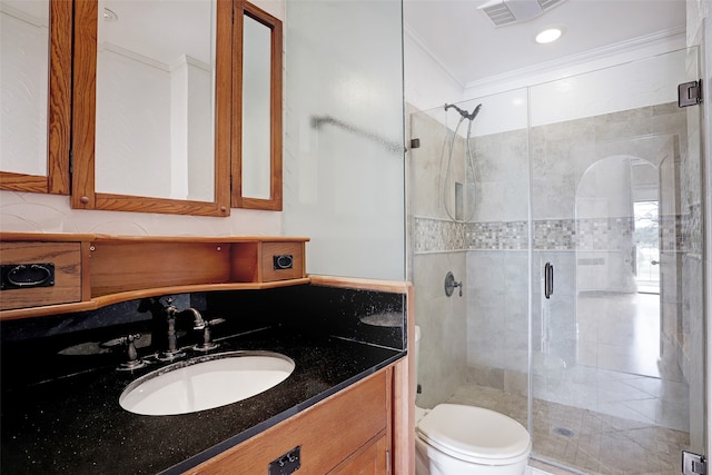 bathroom featuring ornamental molding, vanity, toilet, and an enclosed shower