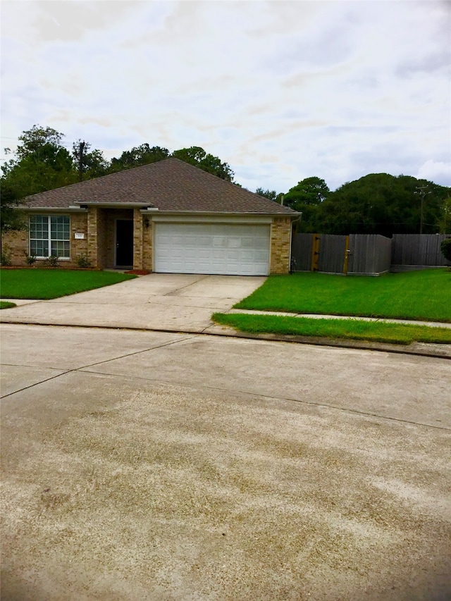 view of front facade featuring a front yard and a garage