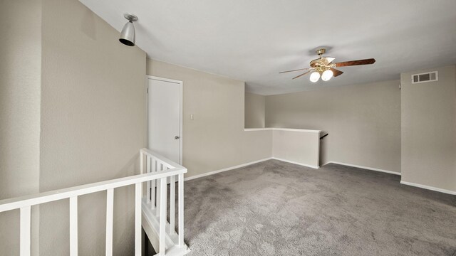 empty room featuring carpet flooring and ceiling fan