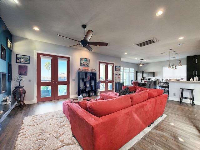 living room with ceiling fan, french doors, and dark wood-type flooring