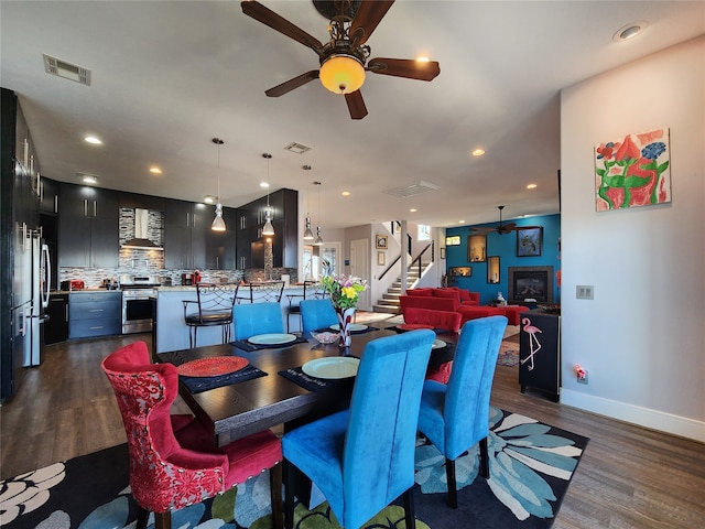 dining space featuring dark hardwood / wood-style flooring and ceiling fan