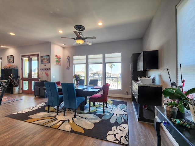 dining space featuring ceiling fan and dark wood-type flooring