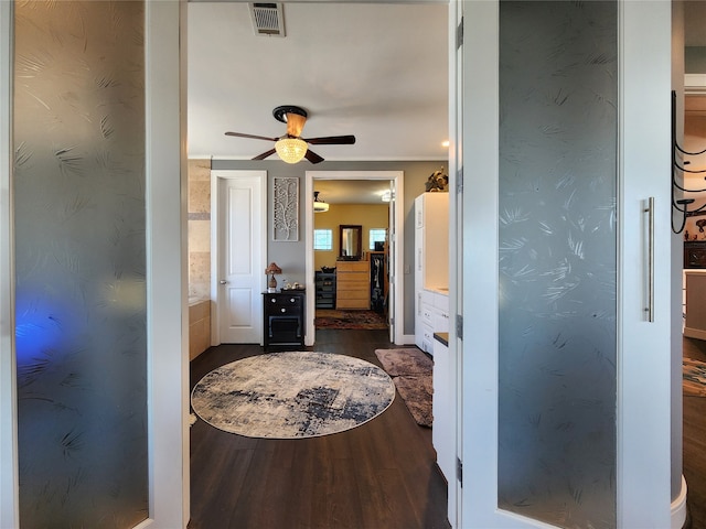 hall with crown molding and dark hardwood / wood-style floors