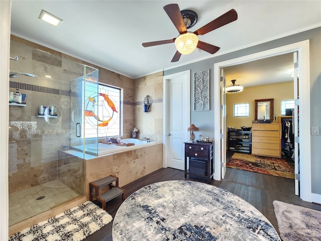 bathroom featuring independent shower and bath, ceiling fan, and wood-type flooring