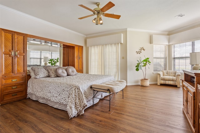 bedroom featuring ceiling fan, hardwood / wood-style flooring, and ornamental molding