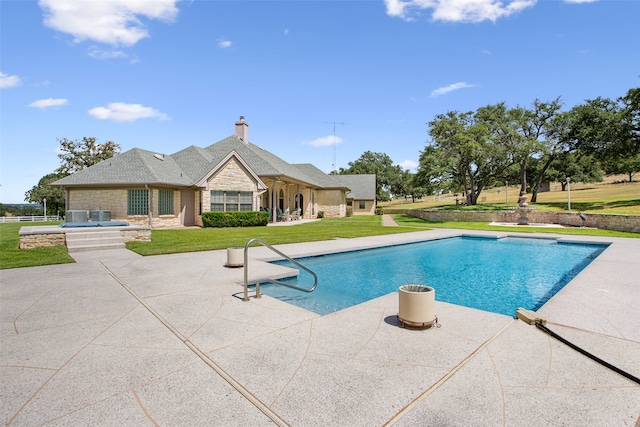 view of swimming pool with a lawn and a patio