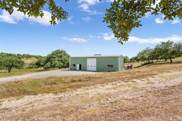 view of front of house with an outdoor structure and a garage