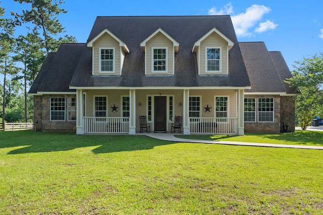 cape cod-style house featuring a front yard and a porch