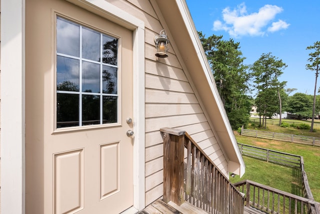 view of exterior entry with a yard