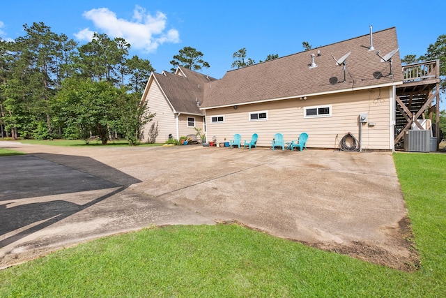 back of house featuring a yard, a patio area, and central AC unit