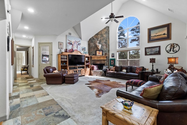 living room featuring high vaulted ceiling, ceiling fan, and a fireplace