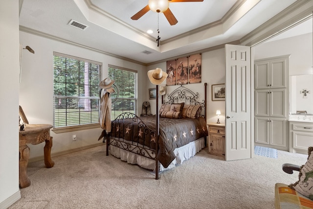 bedroom with light colored carpet, ceiling fan, ornamental molding, and a raised ceiling