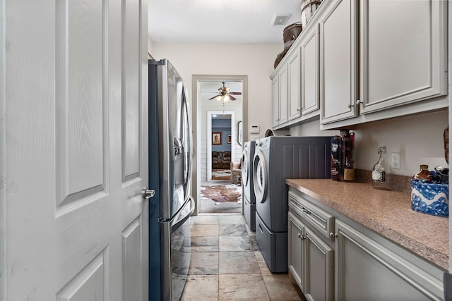 laundry room featuring cabinets, washer and dryer, and ceiling fan