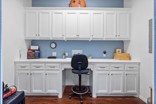 interior space featuring built in desk and dark hardwood / wood-style flooring