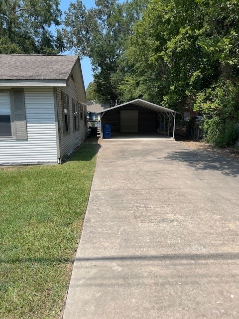 view of home's exterior with a yard and a carport