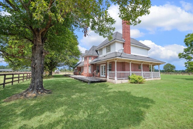 back of house featuring a yard and a wooden deck