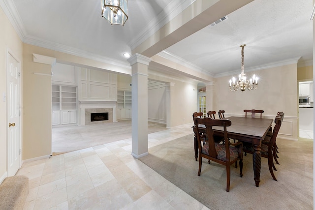 dining room featuring crown molding, light carpet, an inviting chandelier, and decorative columns