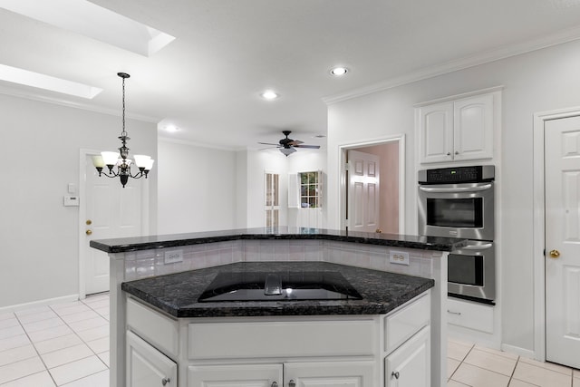 kitchen with double oven, a center island, black electric cooktop, white cabinets, and crown molding