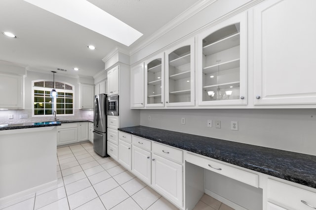 kitchen featuring backsplash, stainless steel fridge, crown molding, pendant lighting, and white cabinetry