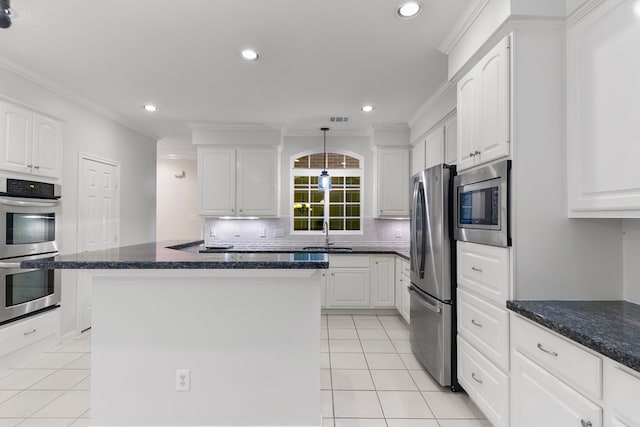 kitchen featuring a kitchen island, white cabinetry, stainless steel appliances, and light tile patterned flooring