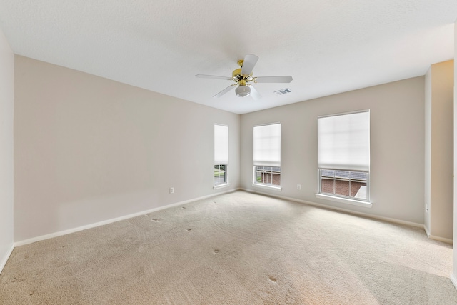 unfurnished room with light colored carpet and ceiling fan