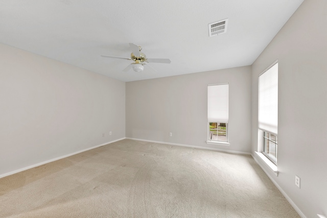 carpeted spare room with ceiling fan