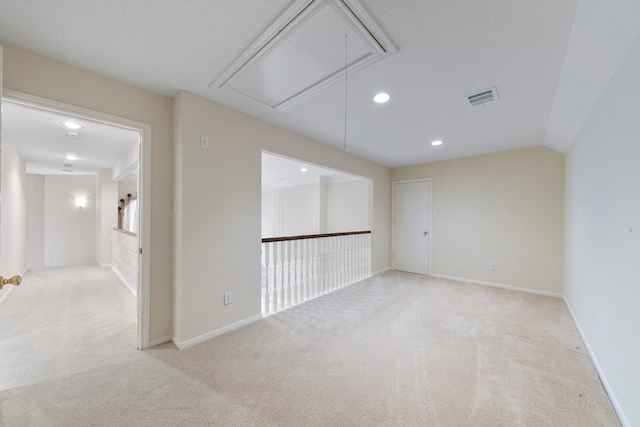 carpeted spare room featuring lofted ceiling