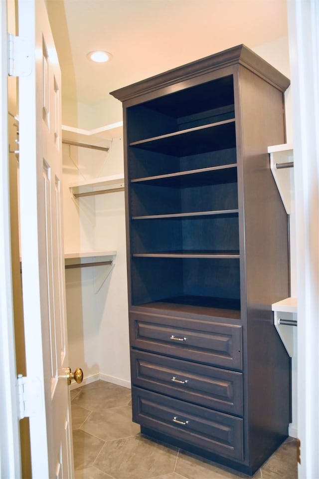 spacious closet featuring light tile patterned flooring