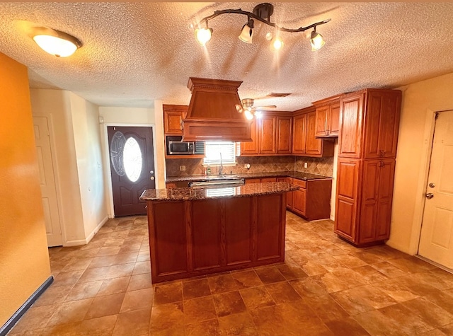 kitchen with a textured ceiling, a kitchen island, and premium range hood