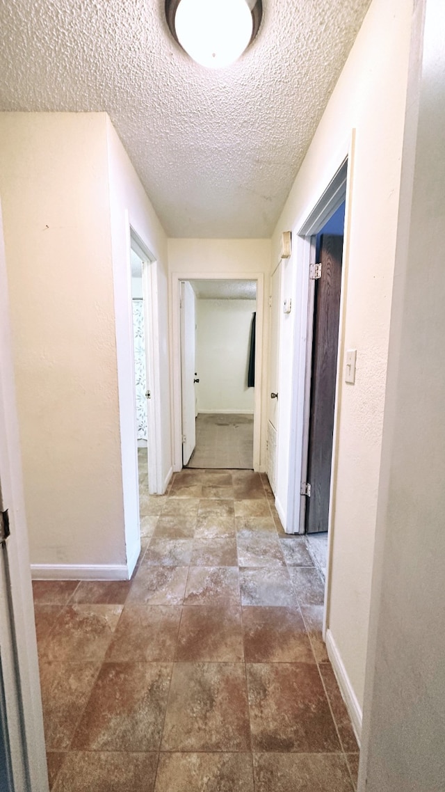 corridor with a textured ceiling