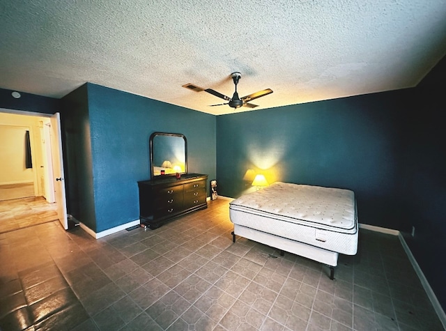 bedroom with ceiling fan and a textured ceiling