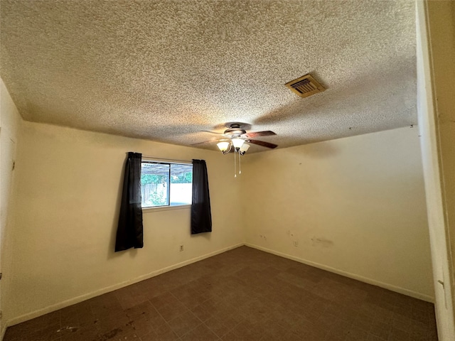 empty room with a textured ceiling and ceiling fan