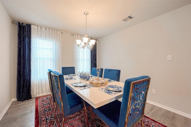 dining room featuring hardwood / wood-style floors and a chandelier